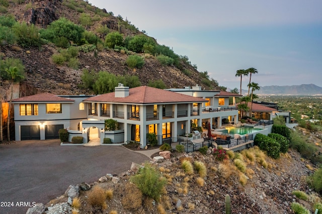 4636 E Moonlight Way, Paradise Valley, AZ 85253 - rear view of house with a balcony, a mountain view, a garage, a chimney, and driveway