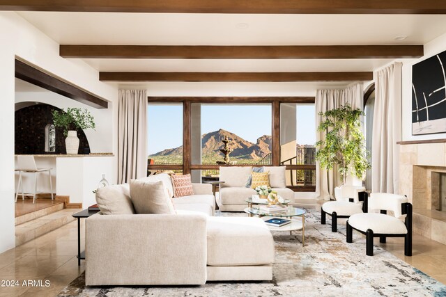 4636 E Moonlight Way, Paradise Valley, AZ 85253 - living room featuring plenty of natural light, a premium fireplace, beamed ceiling, and tile patterned floors