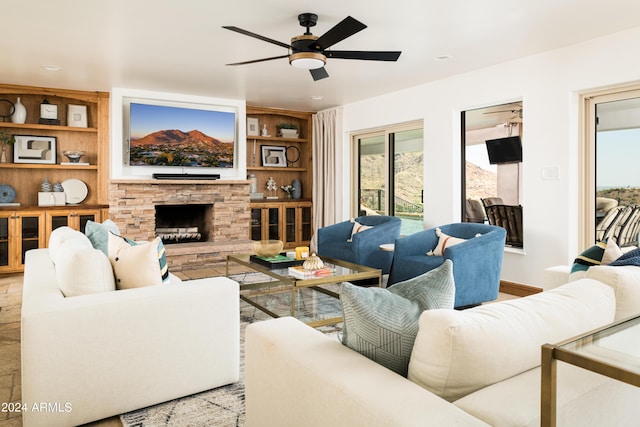 4636 E Moonlight Way, Paradise Valley, AZ 85253 - living area featuring a stone fireplace, a ceiling fan, and built in features