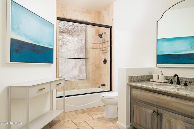 full bathroom featuring enclosed tub / shower combo, toilet, and vanity