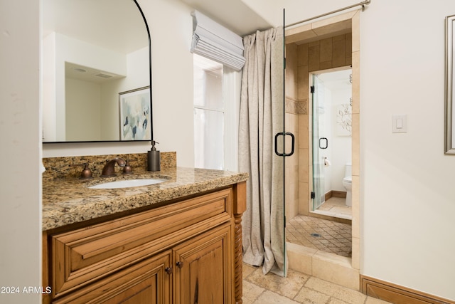 4636 E Moonlight Way, Paradise Valley, AZ 85253 - bathroom with vanity, a stall shower, and toilet