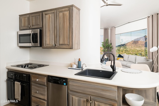 4636 E Moonlight Way, Paradise Valley, AZ 85253 - kitchen with black appliances, a sink, light countertops, and ceiling fan