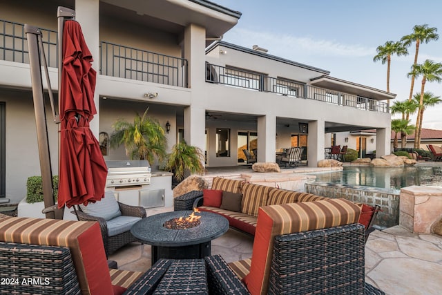 4636 E Moonlight Way, Paradise Valley, AZ 85253 - view of patio with an outdoor living space with a fire pit, a balcony, and an infinity pool