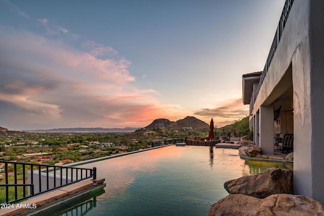 4636 E Moonlight Way, Paradise Valley, AZ 85253 - pool at dusk featuring a mountain view