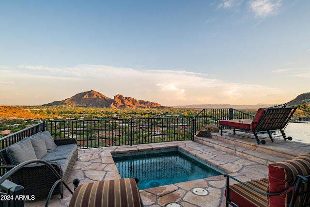 4636 E Moonlight Way, Paradise Valley, AZ 85253 - pool at dusk featuring a mountain view and a patio area