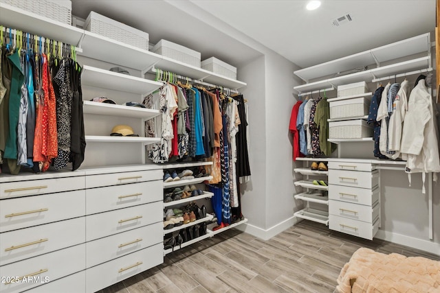 spacious closet featuring light wood-style flooring and visible vents