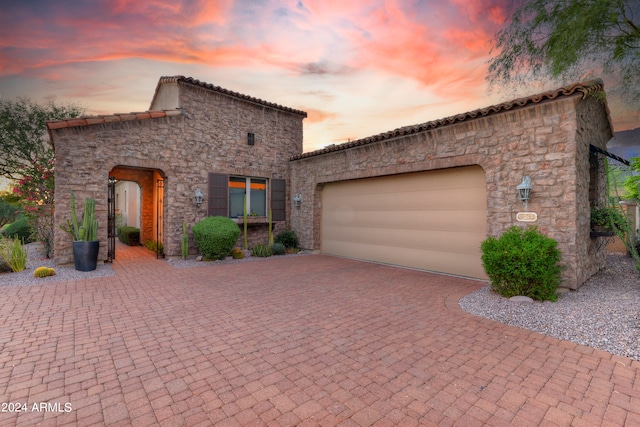 mediterranean / spanish-style home featuring a garage