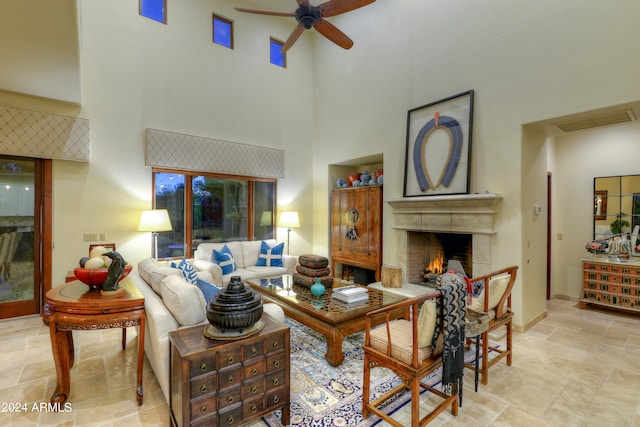 living room featuring a towering ceiling and ceiling fan