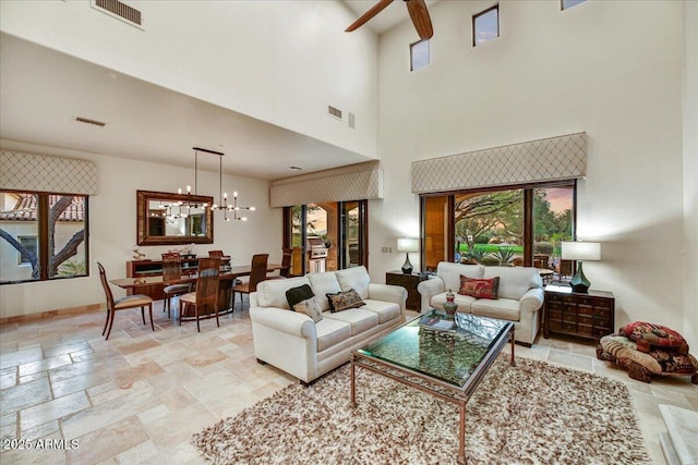 2744 S First Water Ln, Gold Canyon, AZ 85118 - living area with stone tile flooring, ceiling fan with notable chandelier, baseboards, and visible vents