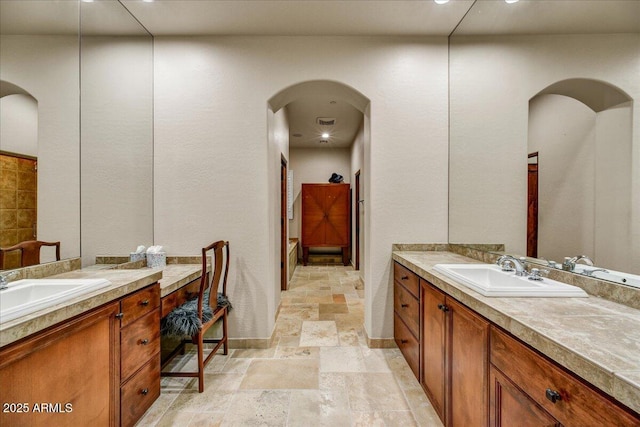 2744 S First Water Ln, Gold Canyon, AZ 85118 - bathroom with a sink, stone tile flooring, and two vanities