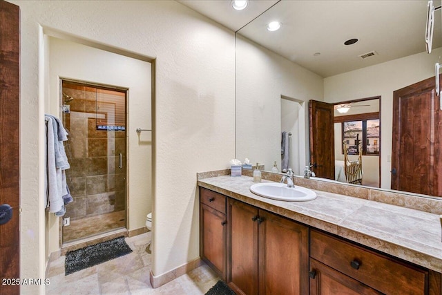2744 S First Water Ln, Gold Canyon, AZ 85118 - bathroom with vanity, toilet, baseboards, a shower stall, and visible vents