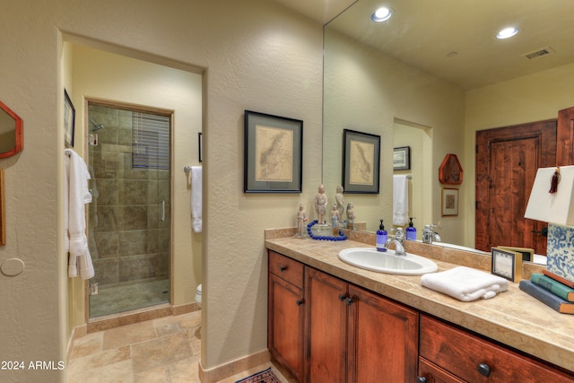 bathroom featuring an enclosed shower, vanity, and toilet