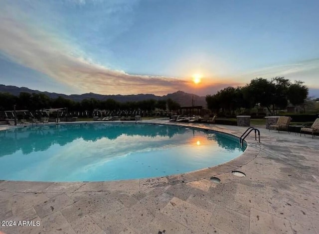 2744 S First Water Ln, Gold Canyon, AZ 85118 - pool at dusk with a patio and a community pool