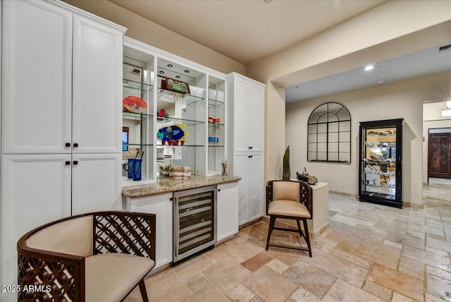 2744 S First Water Ln, Gold Canyon, AZ 85118 - bar with a bar, stone tile flooring, visible vents, and beverage cooler