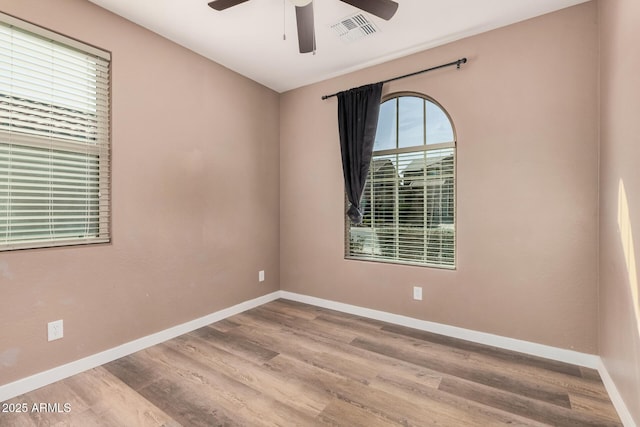 unfurnished room with ceiling fan and hardwood / wood-style floors