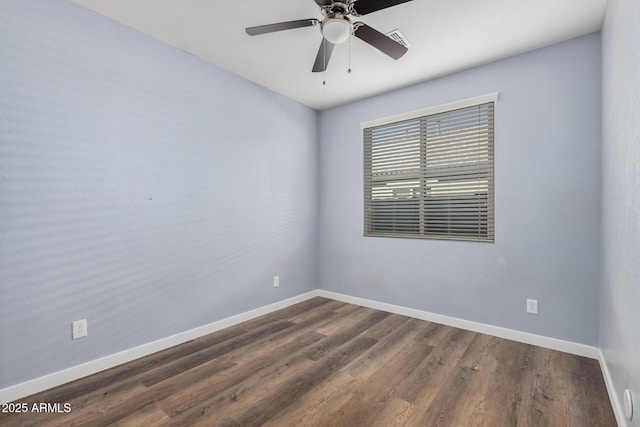 empty room with ceiling fan and dark hardwood / wood-style floors