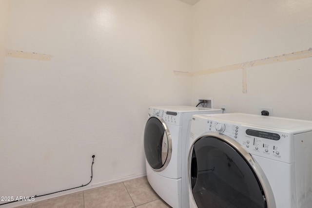 washroom featuring light tile patterned floors and washing machine and clothes dryer