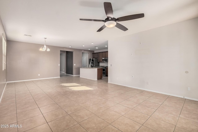 unfurnished living room featuring light tile patterned floors and ceiling fan with notable chandelier