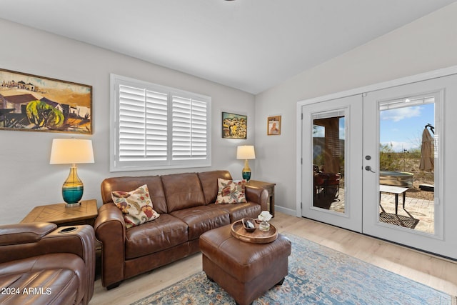 living room featuring plenty of natural light, light hardwood / wood-style flooring, and french doors