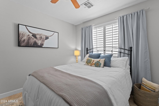 bedroom with light hardwood / wood-style floors and ceiling fan