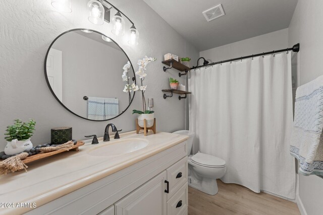 bathroom featuring hardwood / wood-style floors, vanity, and toilet