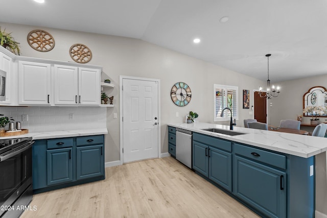 kitchen featuring lofted ceiling, blue cabinets, sink, white cabinetry, and stainless steel appliances