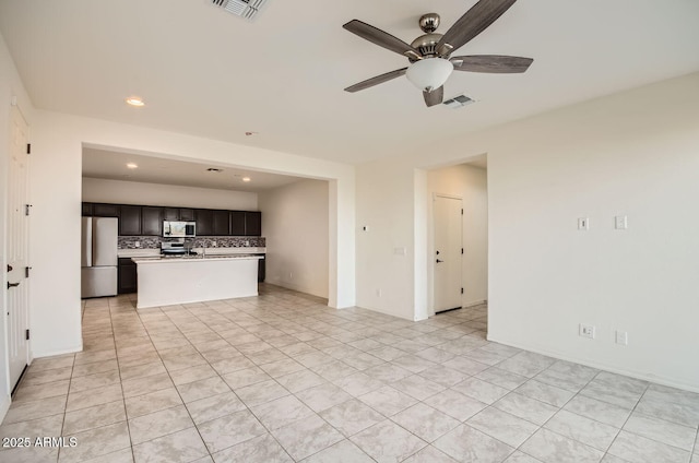 unfurnished living room featuring ceiling fan and light tile patterned floors