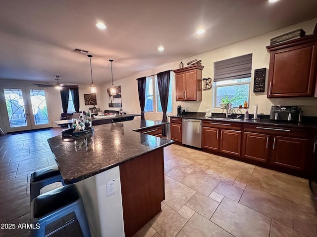 kitchen with ceiling fan, dishwasher, french doors, pendant lighting, and a kitchen island