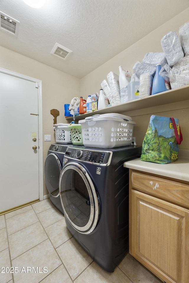 7262 W Firebird Dr, Glendale, AZ 85308 - laundry room featuring independent washer and dryer, light tile patterned floors, a textured ceiling, and cabinet space