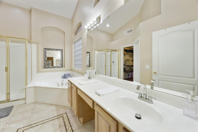7262 W Firebird Dr, Glendale, AZ 85308 - bathroom with a shower stall, tile patterned flooring, a spacious closet, a bath, and double vanity