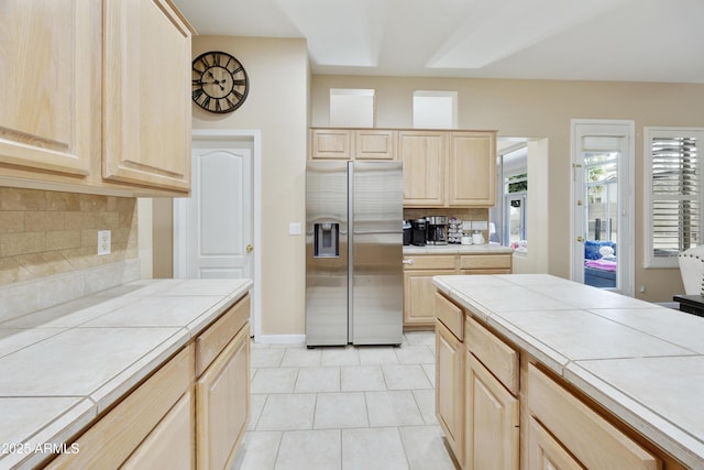7262 W Firebird Dr, Glendale, AZ 85308 - kitchen featuring stainless steel refrigerator with ice dispenser, tile counters, light brown cabinetry, and backsplash