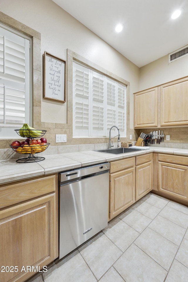 7262 W Firebird Dr, Glendale, AZ 85308 - kitchen featuring dishwasher, light brown cabinets, a sink, decorative backsplash, and light countertops