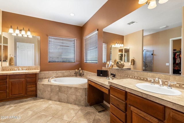 bathroom with vanity, tile patterned flooring, and shower with separate bathtub