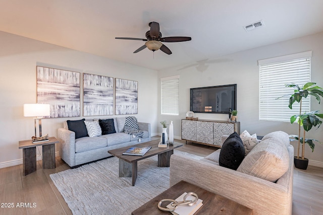 living room featuring ceiling fan and light hardwood / wood-style flooring