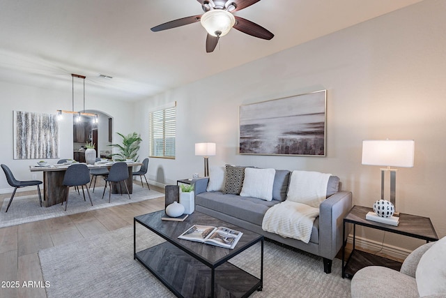 living room with ceiling fan and wood-type flooring