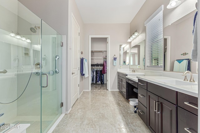 bathroom featuring a shower with door, tile flooring, and double vanity