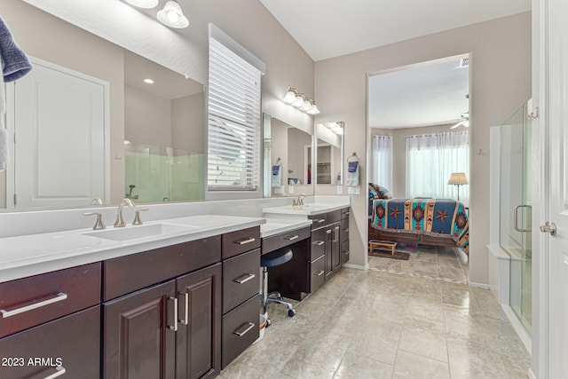 bathroom with double sink, walk in shower, ceiling fan, tile floors, and vanity with extensive cabinet space