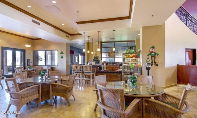 tiled dining room featuring a high ceiling and french doors