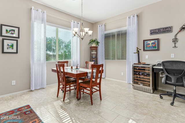 tiled dining room featuring beverage cooler and a chandelier