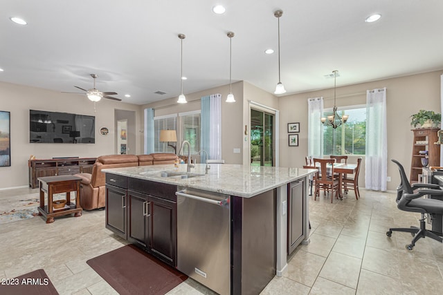 kitchen with hanging light fixtures, ceiling fan with notable chandelier, sink, and light stone countertops