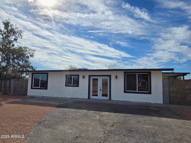 single story home with french doors and fence