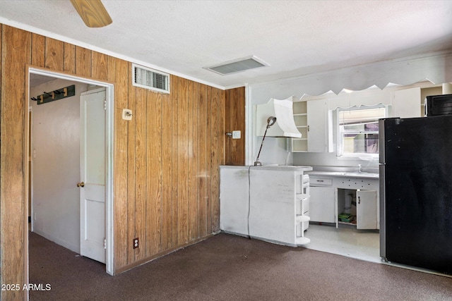 2230 N 12th St Rear, Rear, Phoenix, AZ 85006 - kitchen with freestanding refrigerator, wood walls, carpet floors, custom exhaust hood, and light countertops