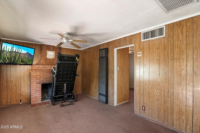 2230 N 12th St Rear, Rear, Phoenix, AZ 85006 - unfurnished living room with a heating unit, wooden walls, a ceiling fan, a fireplace, and carpet flooring