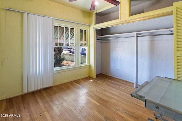2230 N 12th St Rear, Rear, Phoenix, AZ 85006 - unfurnished bedroom with hardwood / wood-style flooring, a textured wall, baseboards, and a ceiling fan
