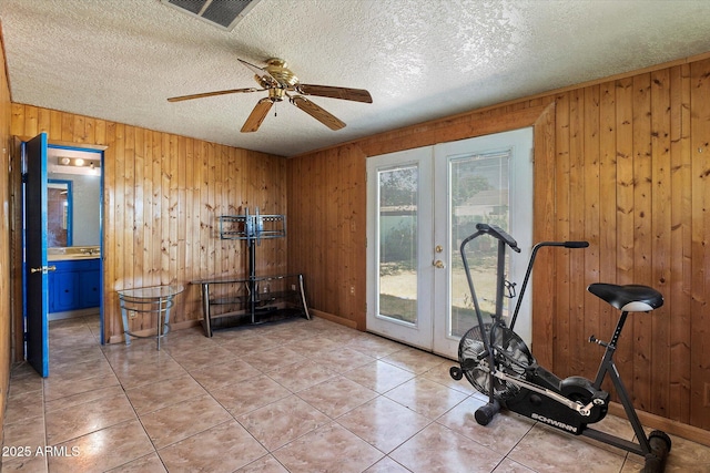 2230 N 12th St Rear, Rear, Phoenix, AZ 85006 - workout room featuring french doors, wooden walls, baseboards, ceiling fan, and a textured ceiling