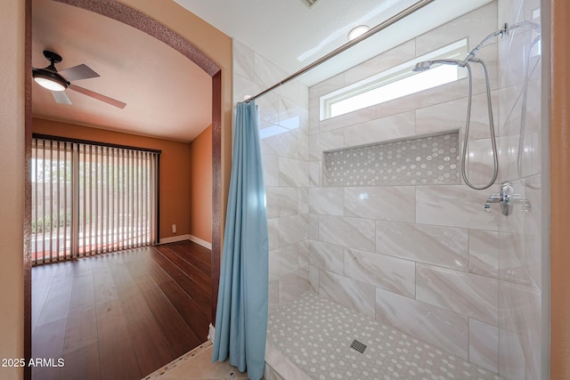 10371 W Pontiac Dr, Peoria, AZ 85382 - full bath featuring tiled shower, a ceiling fan, wood finished floors, and baseboards