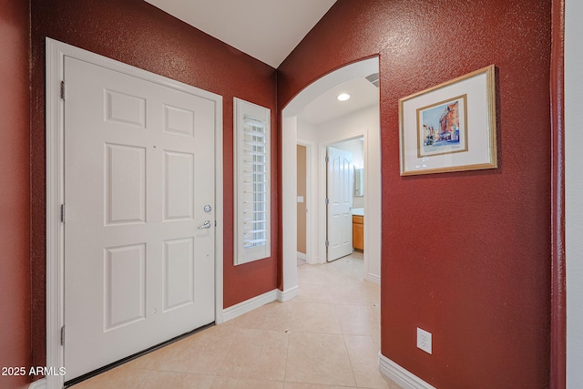 10371 W Pontiac Dr, Peoria, AZ 85382 - entrance foyer featuring arched walkways, light tile patterned floors, baseboards, and a textured wall