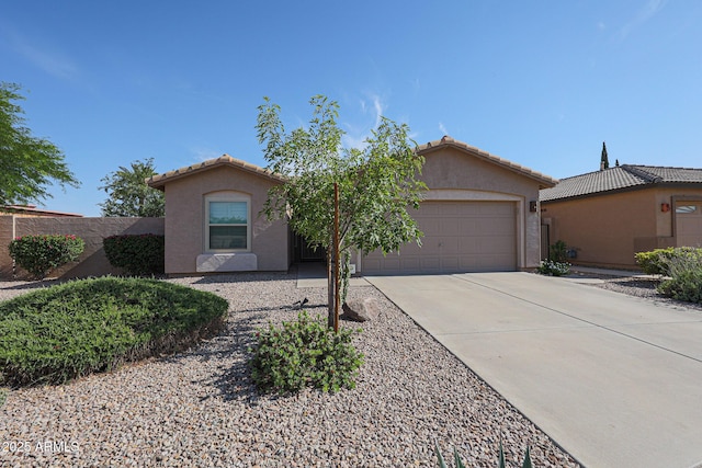 10371 W Pontiac Dr, Peoria, AZ 85382 - view of front of house featuring an attached garage, driveway, stucco siding, and a tile roof