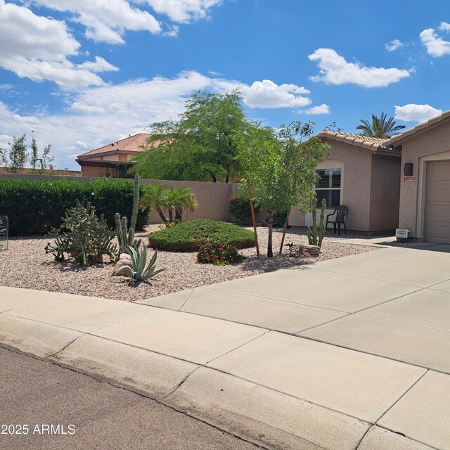 10371 W Pontiac Dr, Peoria, AZ 85382 - view of front of home with stucco siding, driveway, a tile roof, and a garage