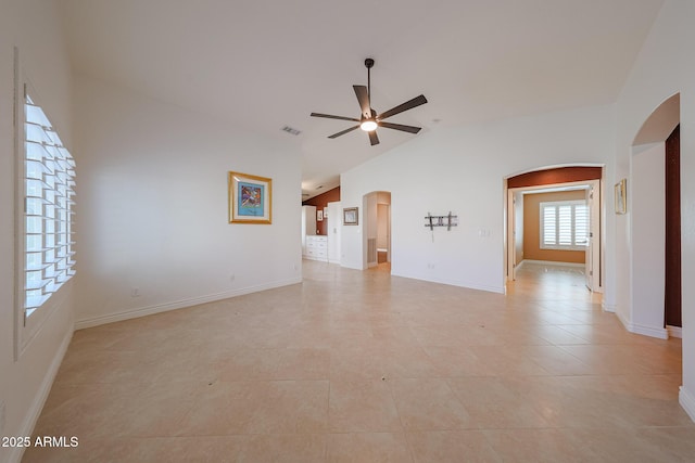 10371 W Pontiac Dr, Peoria, AZ 85382 - unfurnished living room featuring arched walkways, vaulted ceiling, ceiling fan, and baseboards